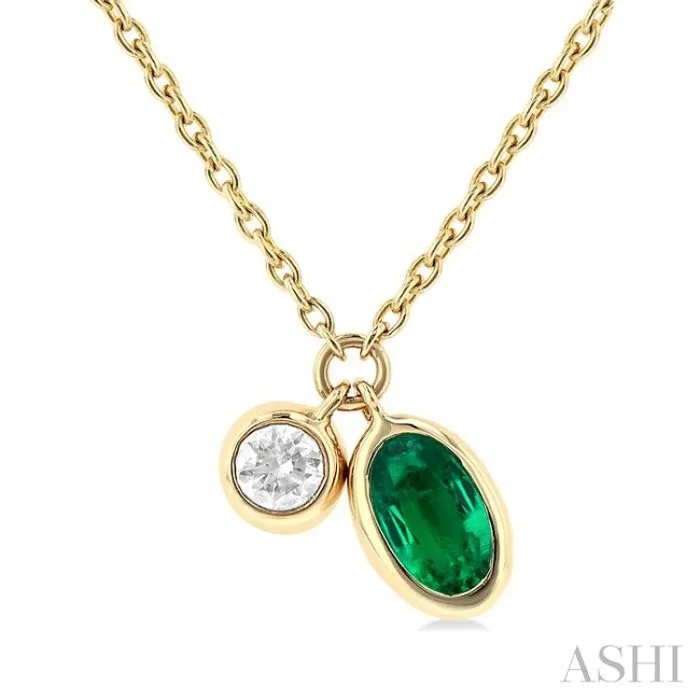 5×3 MM Oval Cut Emerald and 1/50 Ctw Bezel Set Round Cut Diamond Precious Pendant With Chain in 10K Yellow Gold
