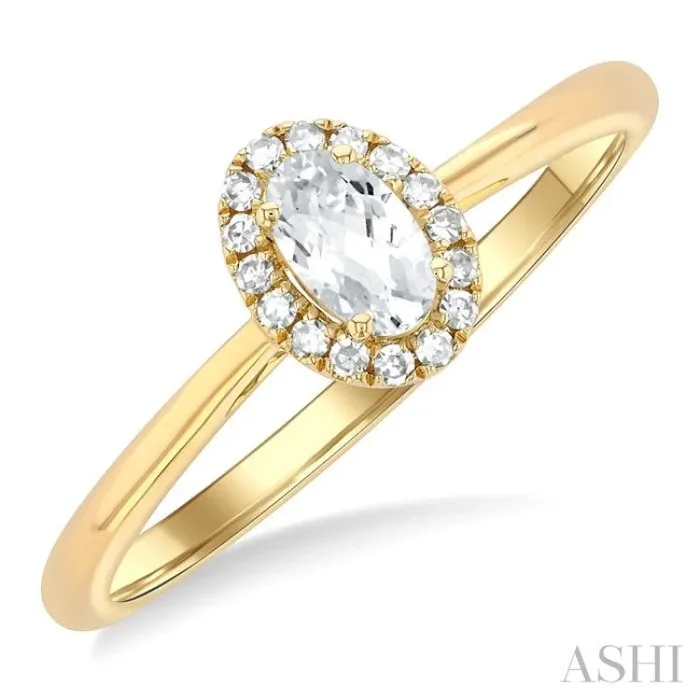 5×3 MM Oval Shape White Topaz and 1/20 Ctw Single Cut Diamond Halo Semi-Precious Ring in 10K Yellow Gold