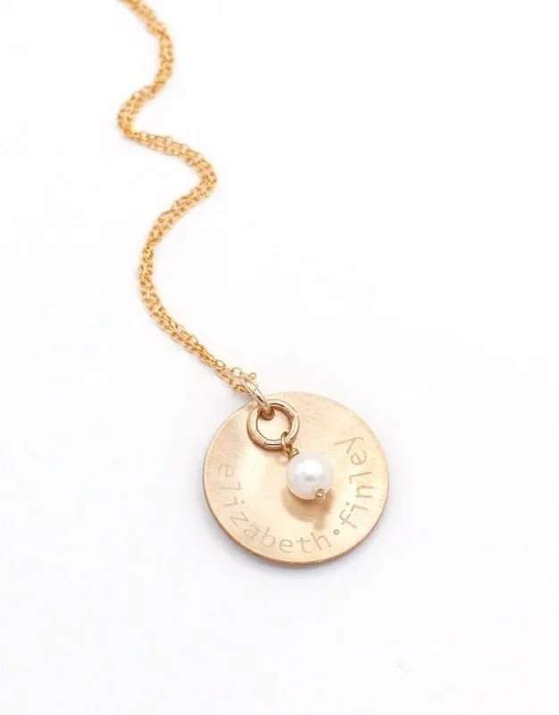 Engraved Gold Names And A Pearl Necklace