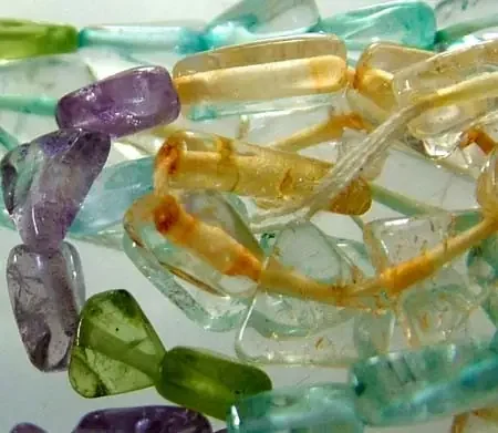 FOUR DIFERENT COLOURFUL STONES IN STRAND 43.45 CTS GT 1575