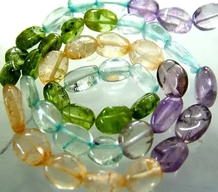 FOUR DIFERENT COLOURFUL STONES IN STRAND 66.15 CTS GT 1595