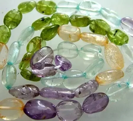 FOUR DIFERENT COLOURFUL STONES IN STRAND 68.90 CTS GT 1599