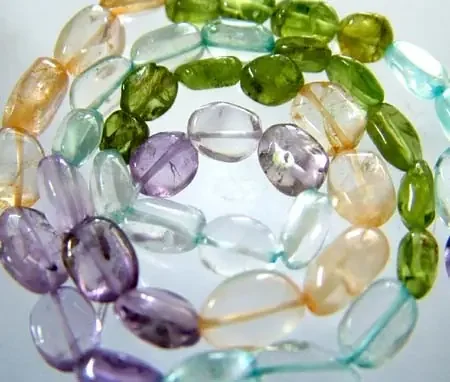 FOUR DIFERENT COLOURFUL STONES IN STRAND 68.95 CTS GT 1602