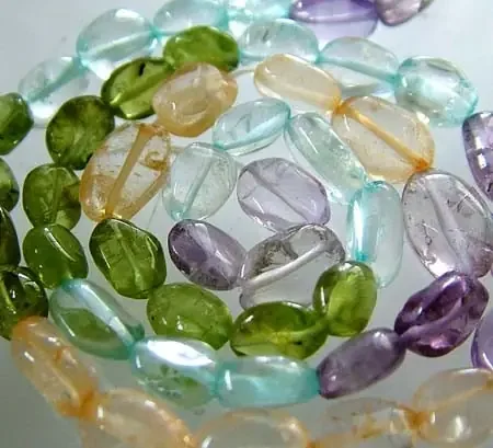 FOUR DIFERENT COLOURFUL STONES IN STRAND 70.60 CTS GT 1605